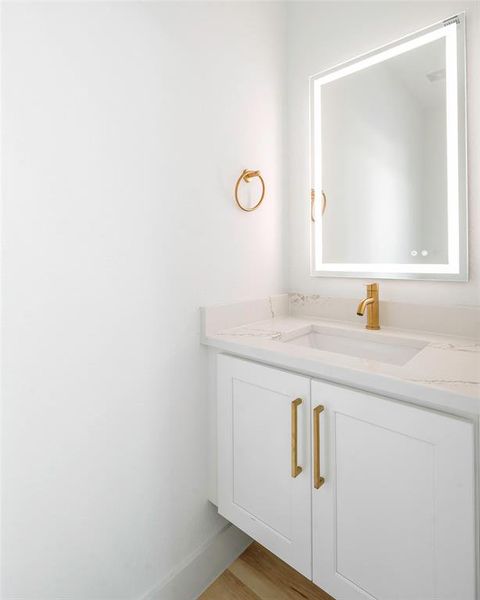 Bathroom featuring hardwood / wood-style flooring and vanity