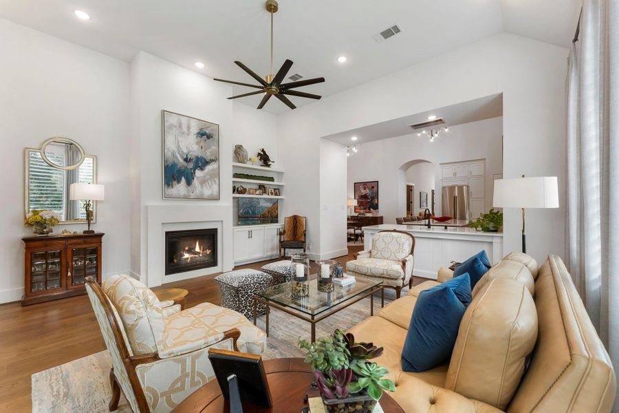 The living room centers around an upgraded fireplace designed to provide both warmth and visual appeal. Custom built-ins create a comfortable gathering space with a refined, finished feel.