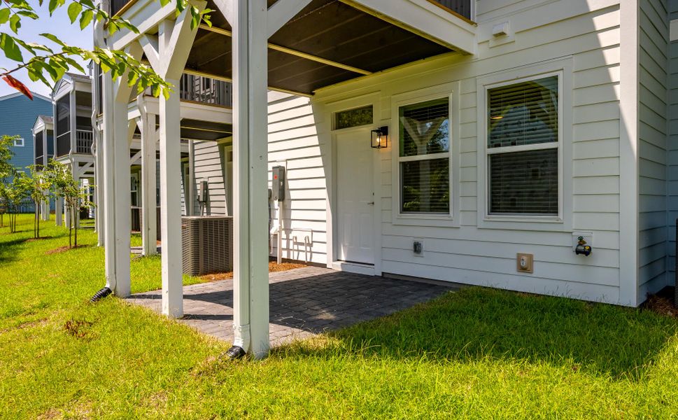 Exterior details and patio area of a home in The Bluffs at Pinefield Townhomes, Charleston (Image 3).