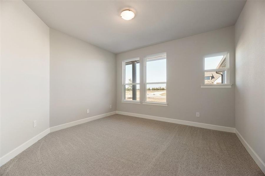 Spare room featuring baseboards and light colored carpet Spare room featuring baseboards and light colored carpet