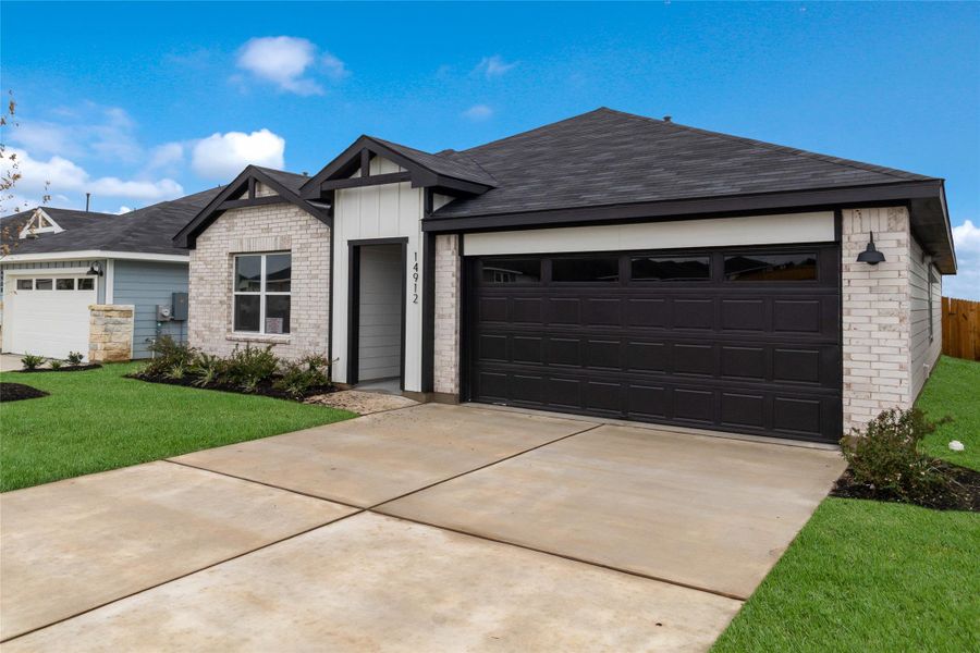 Front exterior of a new home in Monarch Ranch, Manor, TX, highlighting curb appeal (Image 23). Front exterior of a new home in Monarch Ranch, Manor, TX, highlighting curb appeal (Image 23).
