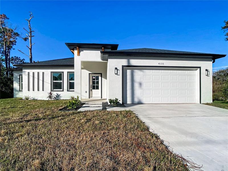 Front exterior of a new home in , North Port, FL, highlighting curb appeal (Image 26).