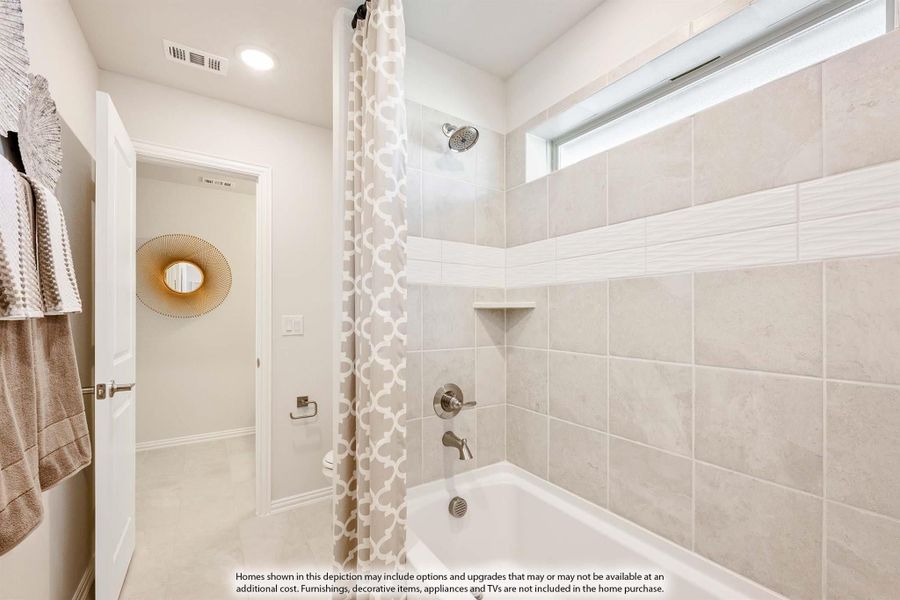 Bathroom with tiled shower-tub combo, curtain, and separate water closet visible through doorway Bathroom with tiled shower-tub combo, curtain, and separate water closet visible through doorway