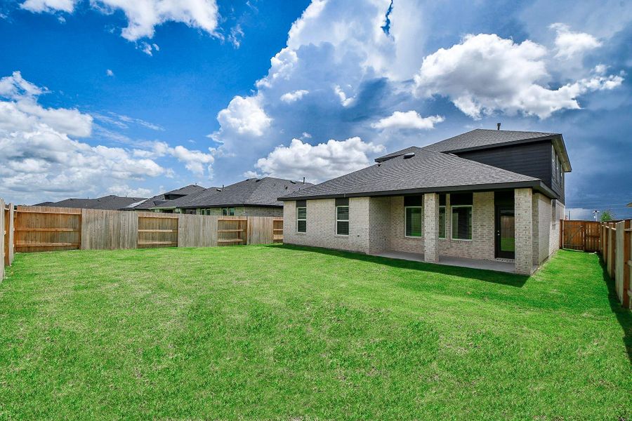 This elegant two-story home features a modern design with a stylish blend of light brick and dark siding. Enjoy the private, fenced backyard—your perfect retreat.