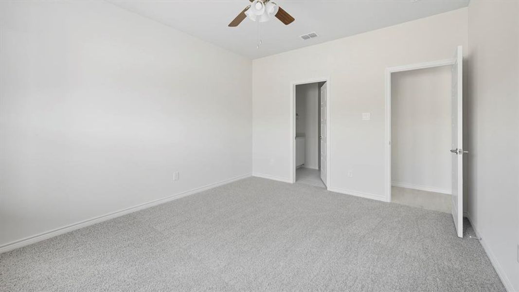 Unfurnished bedroom with carpet floors, a ceiling fan, and ensuite bathroom Unfurnished bedroom with carpet floors, a ceiling fan, and ensuite bathroom