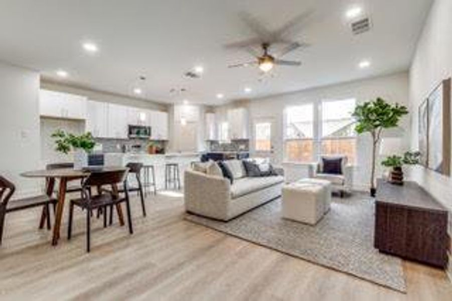 Living room with light hardwood / wood-style floors and ceiling fan