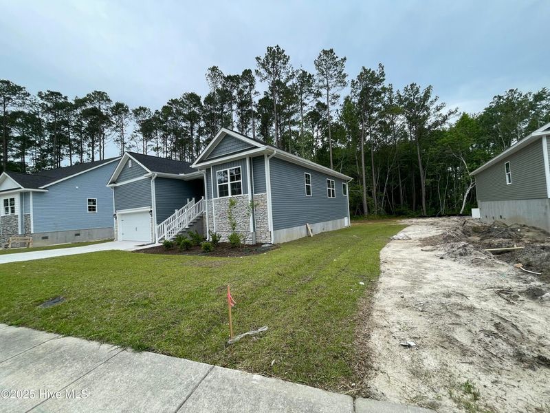 Front exterior of a new home in Mill Creek Cove, Bolivia, NC, highlighting curb appeal (Image 9).