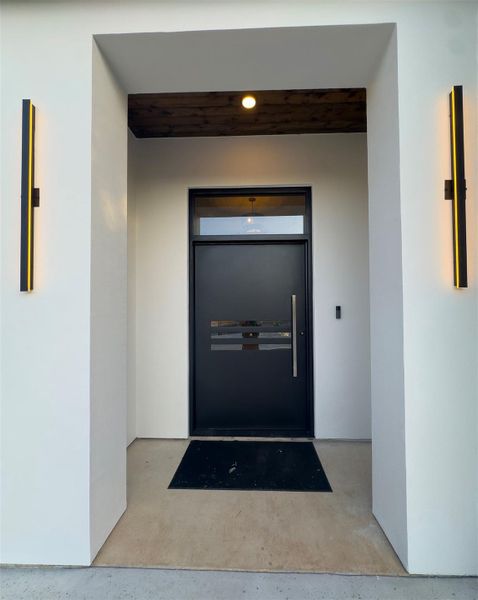 Sleek contemporary design welcomes visitors at this recessed entrance with bold vertical lighting accents. Sleek contemporary design welcomes visitors at this recessed entrance with bold vertical lighting accents.