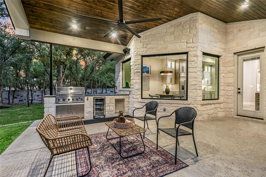 View of patio / terrace featuring area for grilling, ceiling fan, and wine cooler View of patio / terrace featuring area for grilling, ceiling fan, and wine cooler
