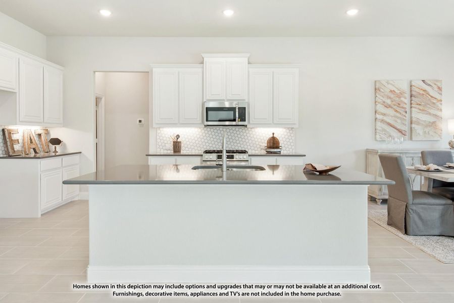 Kitchen with large center island, white cabinets, gray countertops, and hexagon tile backsplash Kitchen with large center island, white cabinets, gray countertops, and hexagon tile backsplash