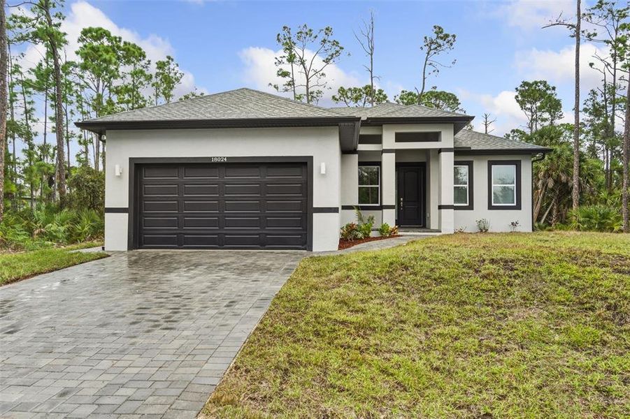 Front exterior of a new home in , Port Charlotte, FL, highlighting curb appeal (Image 1).