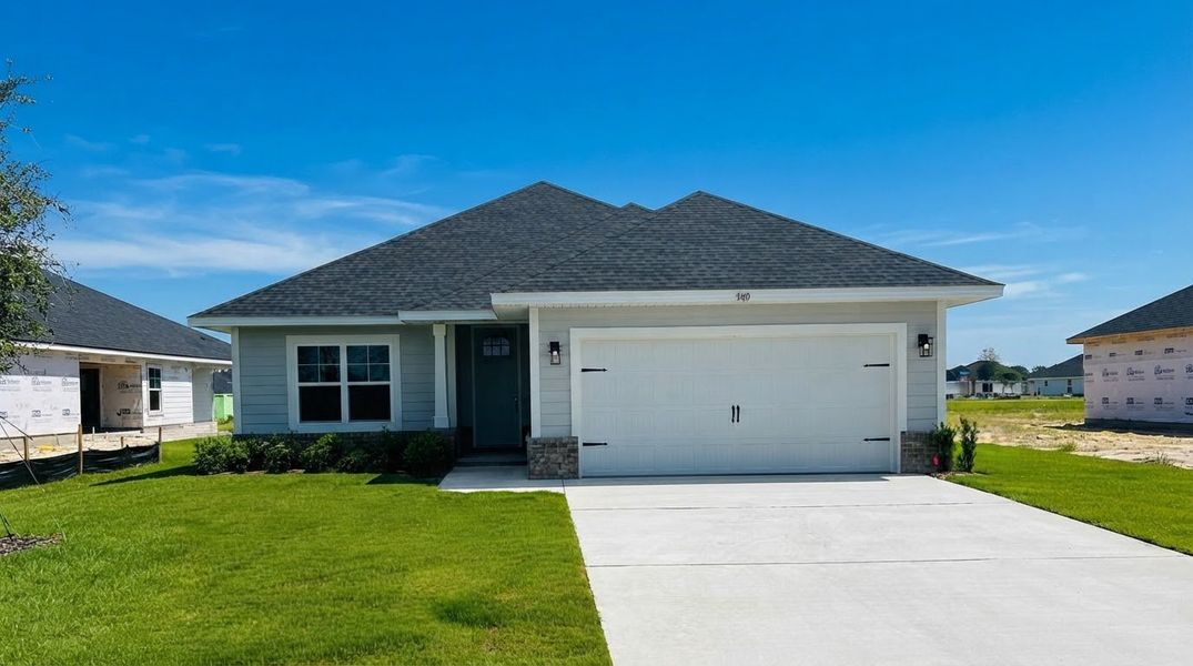 Front exterior of a new home in The Bluffs at Lafayette, Freeport, FL, highlighting curb appeal (Image 1). Front exterior of a new home in The Bluffs at Lafayette, Freeport, FL, highlighting curb appeal (Image 1).