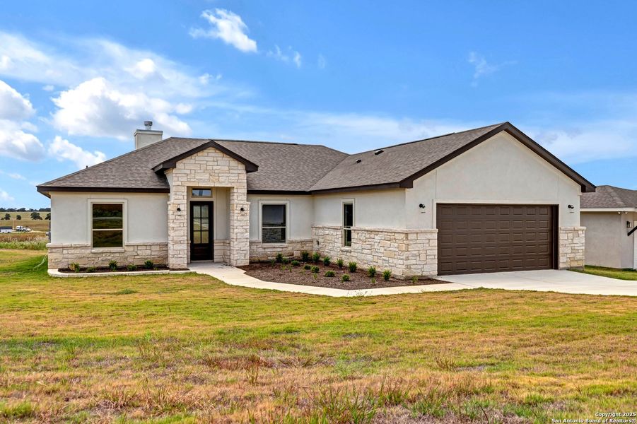 Front exterior of a new home in , La Vernia, TX, highlighting curb appeal (Image 26). Front exterior of a new home in , La Vernia, TX, highlighting curb appeal (Image 26).