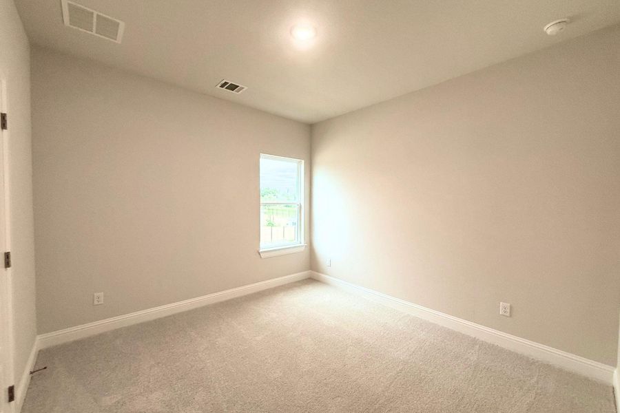 Well-lit and tranquil, this bedroom provides a peaceful retreat with plush carpeting and natural light. Well-lit and tranquil, this bedroom provides a peaceful retreat with plush carpeting and natural light.