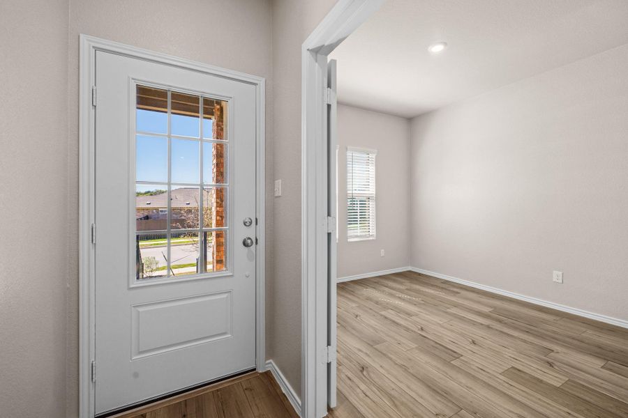 Entryway featuring wood finished floors and baseboards