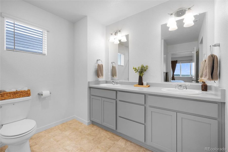 Spacious primary bathroom with dual sink vanity.