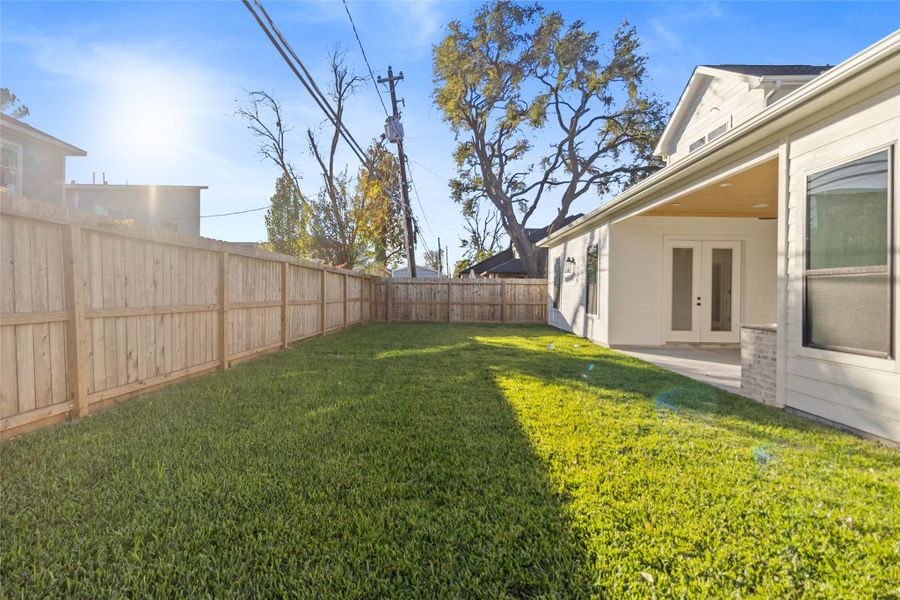 You step out back to a wide, level yard with fresh grass and full privacy fencing—perfect for letting the dog run, hosting weekend games, or finally setting up that fire pit you’ve been picturing.