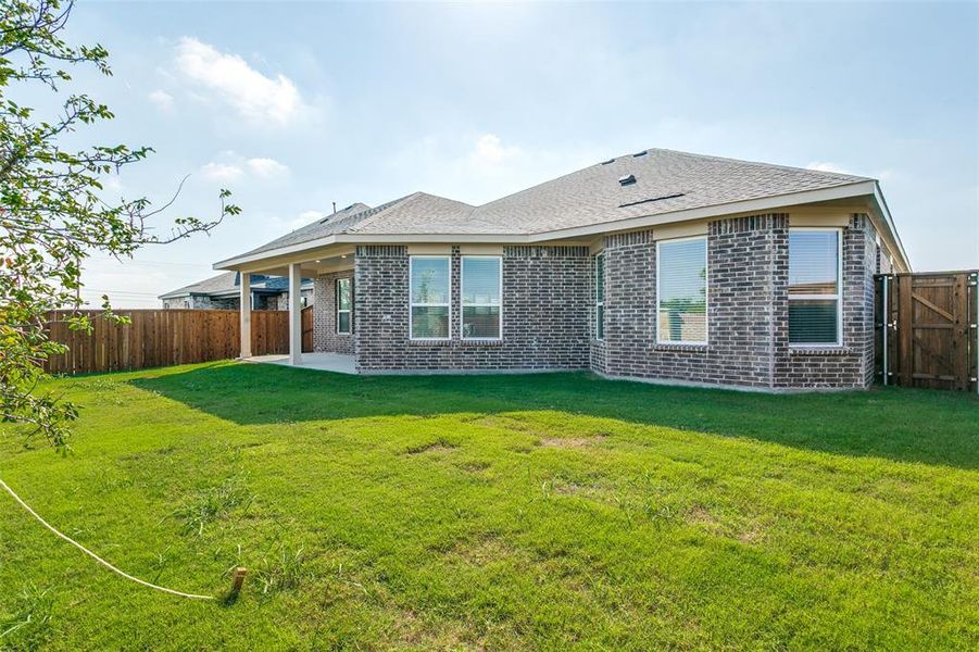 Exterior details and patio area of a home in The Preserve Estates, Justin (Image 19).