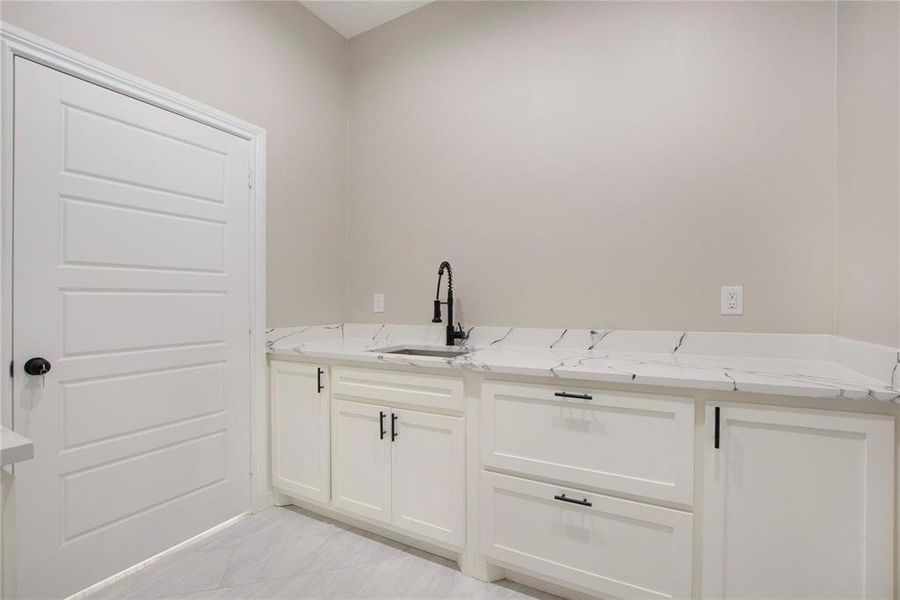 Laundry area featuring a sink Laundry area featuring a sink