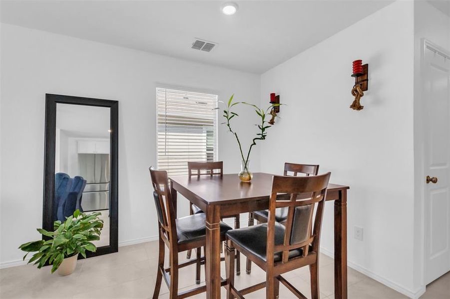 Dining space featuring recessed lighting and light tile patterned floors