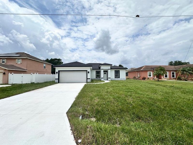 Front exterior of a new home in , Poinciana, FL, highlighting curb appeal (Image 23). Front exterior of a new home in , Poinciana, FL, highlighting curb appeal (Image 23).