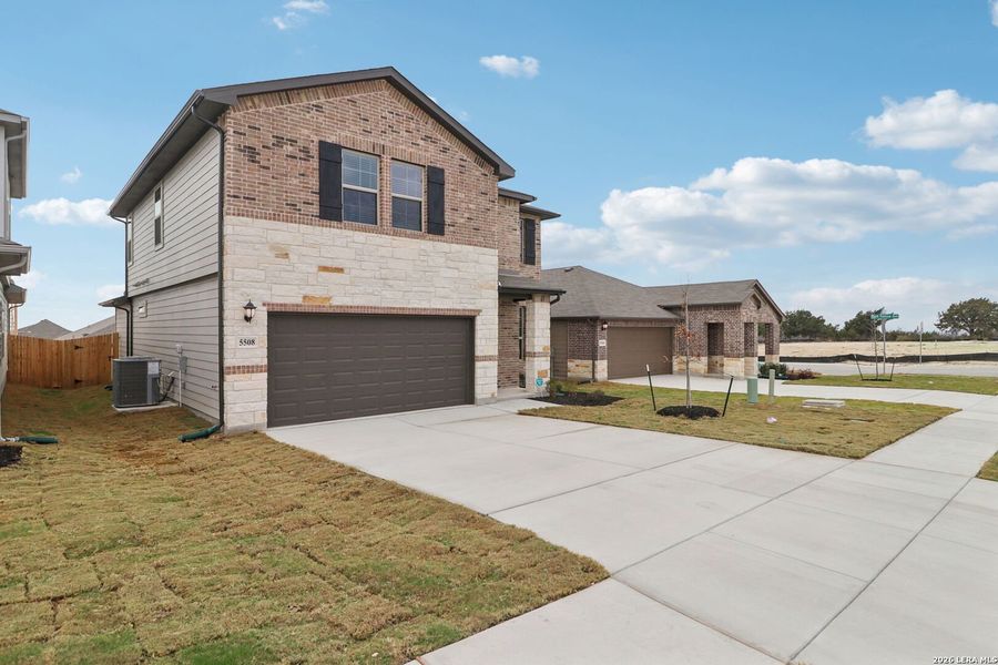 Front exterior of a new home in Legendary Trails - Premier Series, Cibolo, TX, highlighting curb appeal (Image 22).