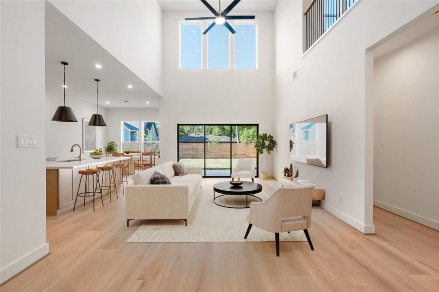 The living area impresses with soaring ceilings and a breathtaking view of the serene backyard, seamlessly connected to the open-concept kitchen—perfect for both everyday living and entertaining. The living area impresses with soaring ceilings and a breathtaking view of the serene backyard, seamlessly connected to the open-concept kitchen—perfect for both everyday living and entertaining.