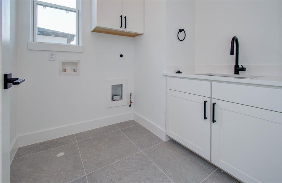 Walk-in laundry features a wash sink