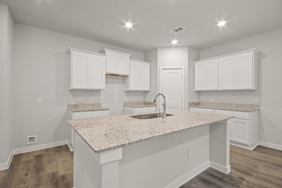 A kitchen with white cabinets. A kitchen with white cabinets.