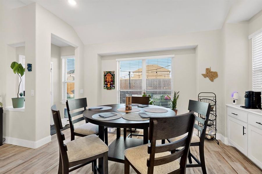 Dining room with light wood-style flooring, healthy amount of natural light, and vaulted ceiling Dining room with light wood-style flooring, healthy amount of natural light, and vaulted ceiling