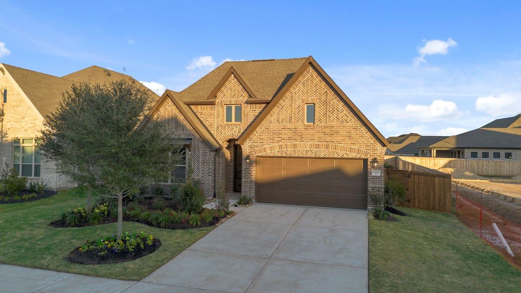 Front exterior of a new home in Dunham Pointe, Cypress, TX, highlighting curb appeal (Image 21).