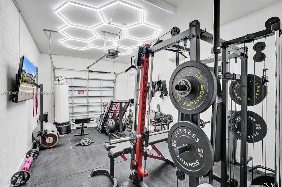 Rubberized flooring, hexagonal ceiling lighting, perfect for gym equipment