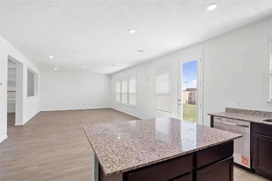 The centerpiece of the kitchen, this island features a Luna Pearl granite countertop and offers both functional storage and additional prep space.