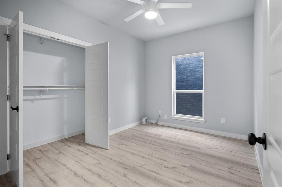 Unfurnished bedroom featuring ceiling fan and light wood finished floors Unfurnished bedroom featuring ceiling fan and light wood finished floors