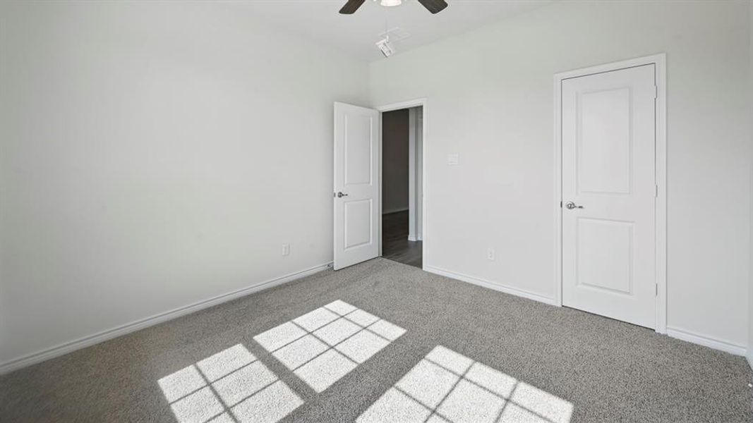 Unfurnished bedroom with carpet and a ceiling fan