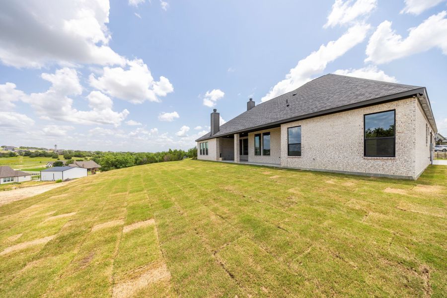 Front exterior of a new home in Vintage Oaks, Weatherford, TX, highlighting curb appeal (Image 41).