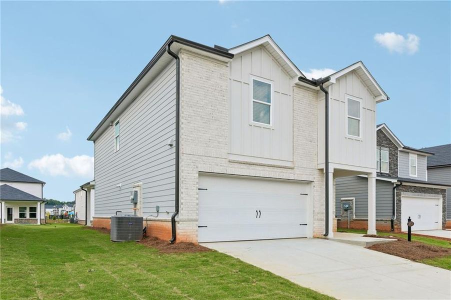 Front exterior of a new home in Martin Springs - Reserve Series, Lawrenceville, GA, highlighting curb appeal (Image 2). Front exterior of a new home in Martin Springs - Reserve Series, Lawrenceville, GA, highlighting curb appeal (Image 2).