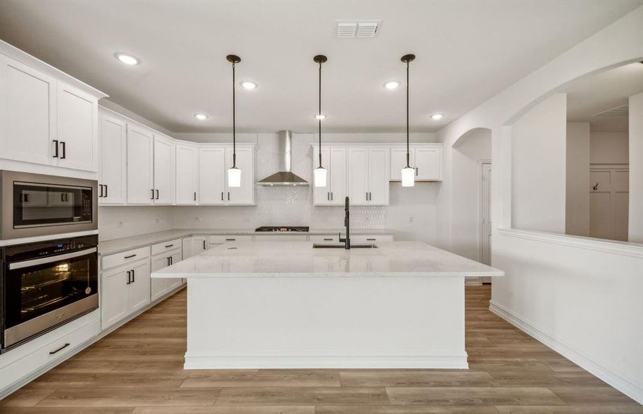 Bright kitchen with oversized island*real home pictured