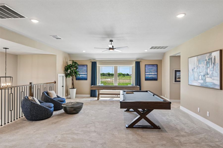 Upstairs game room with pool table, seating area, and large window with outdoor views Upstairs game room with pool table, seating area, and large window with outdoor views