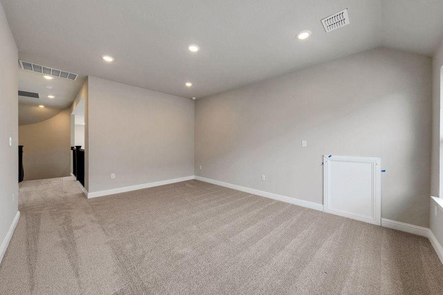 Carpeted spare room with recessed lighting and vaulted ceiling Carpeted spare room with recessed lighting and vaulted ceiling