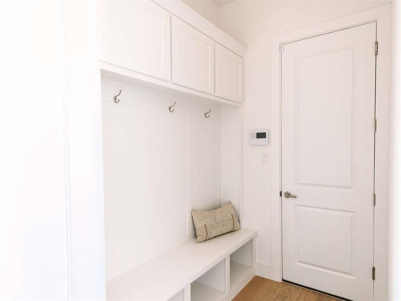 Mudroom with light hardwood / wood-style floors