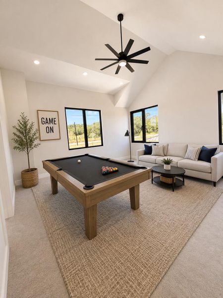 A versatile bonus room featuring a full-sized billiard table, lofty vaulted ceilings, and a relaxing lounge area.
