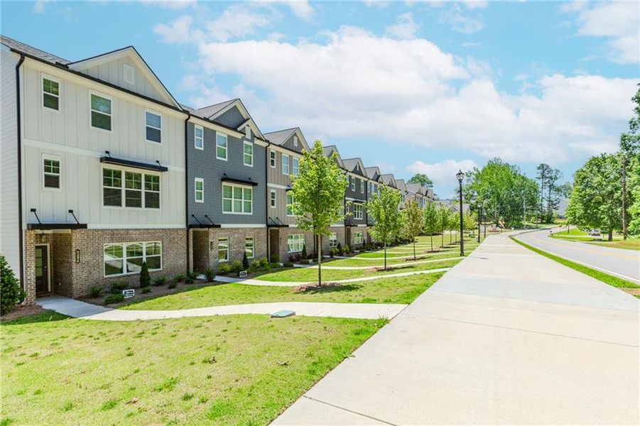 Front exterior of a new home in Hillcrest Landing, Sugar Hill, GA, highlighting curb appeal (Image 1). Front exterior of a new home in Hillcrest Landing, Sugar Hill, GA, highlighting curb appeal (Image 1).