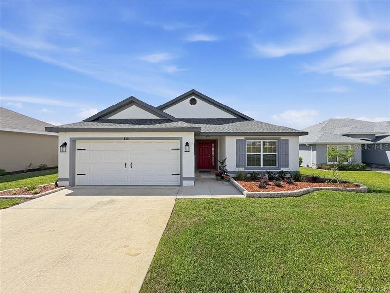 Front exterior of a new home in The Fairways At Twisted Oaks, Beverly Hills, FL, highlighting curb appeal (Image 24).