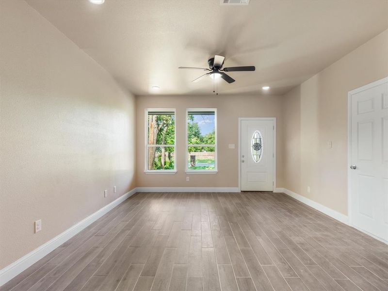 Foyer entrance with a ceiling fan and wood finished floors Foyer entrance with a ceiling fan and wood finished floors