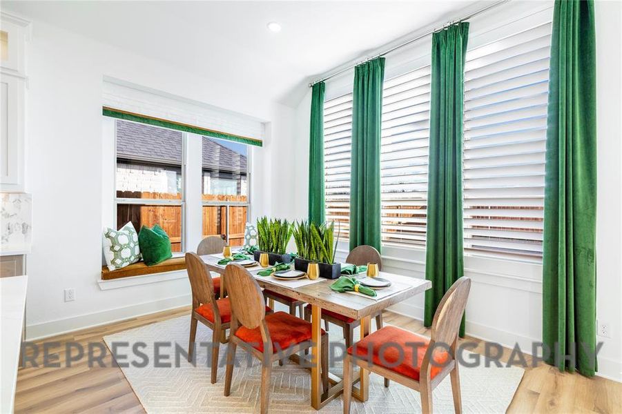 Dining room with light wood-type flooring and recessed lighting Dining room with light wood-type flooring and recessed lighting