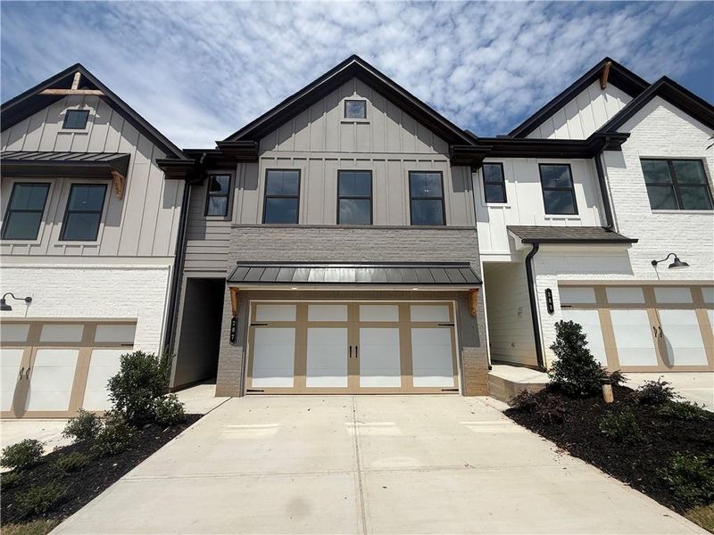 Front exterior of a new home in The Towns at Auburn Station East, Auburn, GA, highlighting curb appeal (Image 1). Front exterior of a new home in The Towns at Auburn Station East, Auburn, GA, highlighting curb appeal (Image 1).