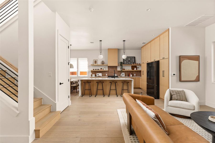 Living room featuring stairs and light wood finished floors
