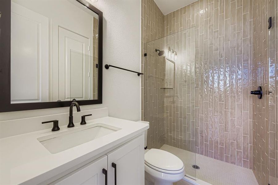 Full bath featuring a walk in shower and vanity