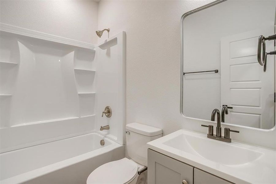 Full bath featuring vanity and shower / bath combination